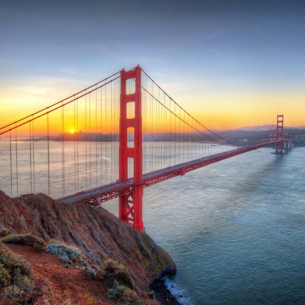 Luxury San Francisco Holiday - Golden Red Gate Bridge at sunrise over water