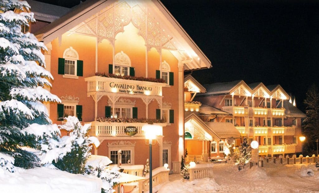 Cavallino Bianco luxury family friendly hotel italy snow covered building orange