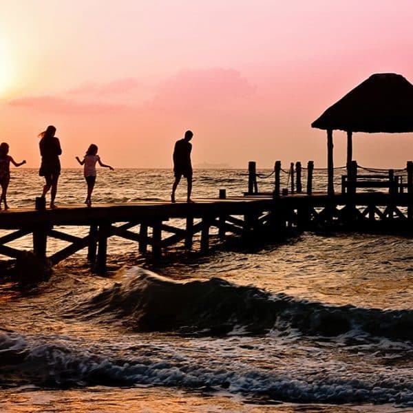 luxury family friendly hotels family on pier on beach