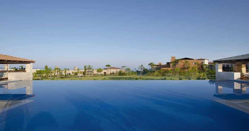 View across the pool at The Romanos, A Luxury Collection Resort in Costa Navarino, Greece