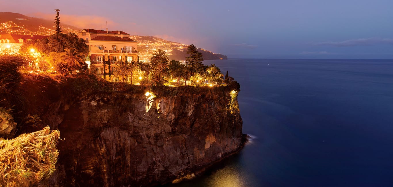 Night view overlooking the sea and the lights of the Belmond Reid's Palace in Funchal, Madeira