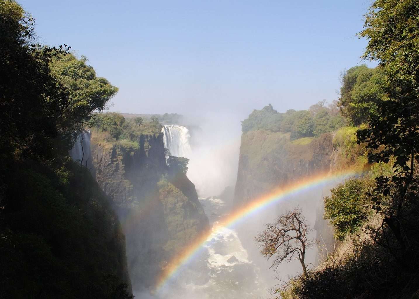 View of Victoria Falls Zambezi with rainbow in spray, part of the Kruger and Victoria Falls tour