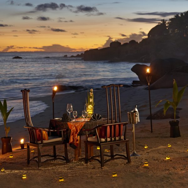 Romantic dining on the beach with candle light at Banyan Tree Seychelles