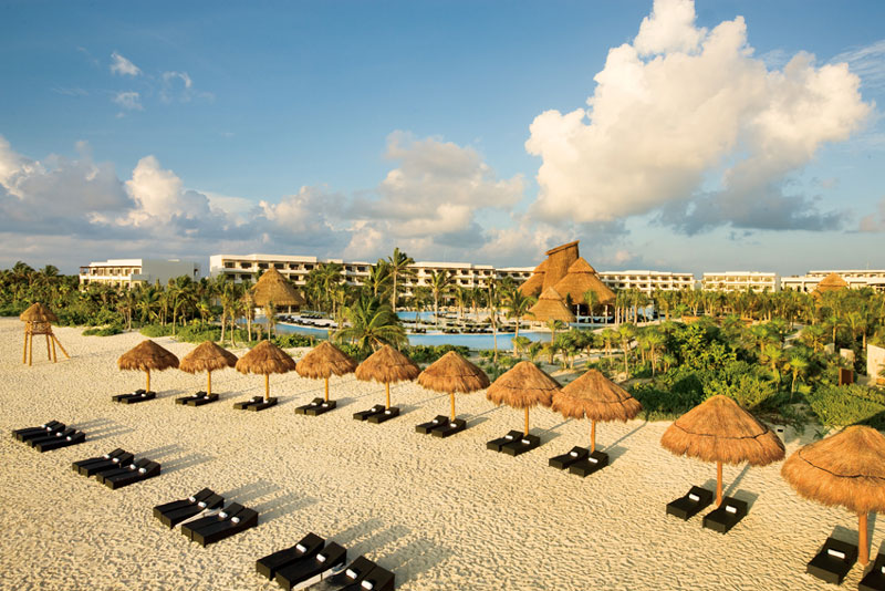 View of the beach and sun loungers at Secrets Maroma Beach in Riviera Cancun, Mexico