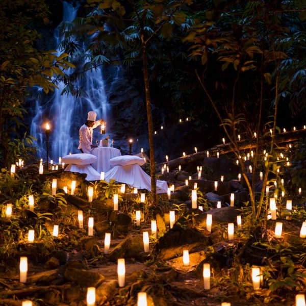 View of the romantic dining by the waterfall in the evening at The Sarojin, Khao Lak in Thailand