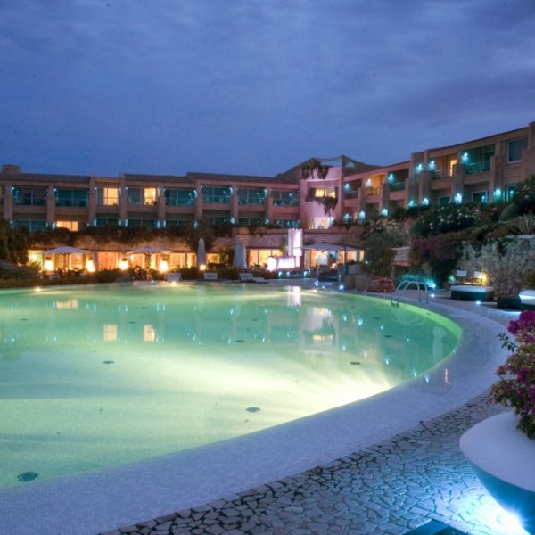 View of the swimming pool and resort in the evening at L Ea Bianca Luxury Resort in Sardinia