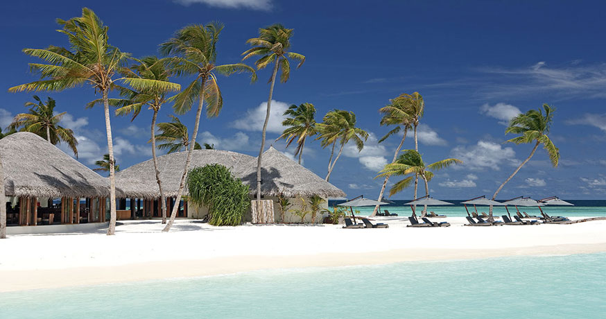 View of the beach and accommodation at Constance Halaveli in Maldives