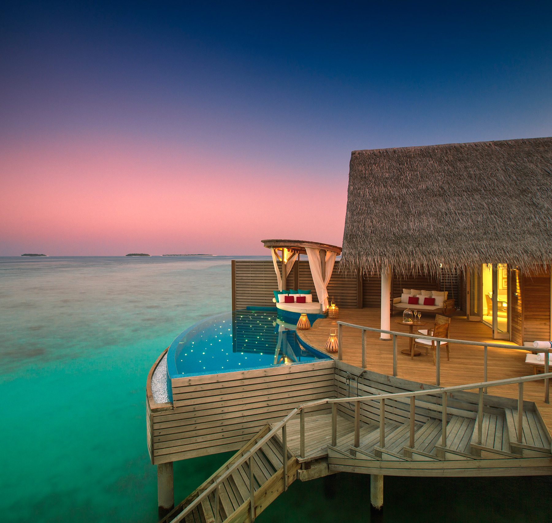 View across the Indian Ocean and the Water Pool Villa at Milaidhoo Island in the Maldives at dusk