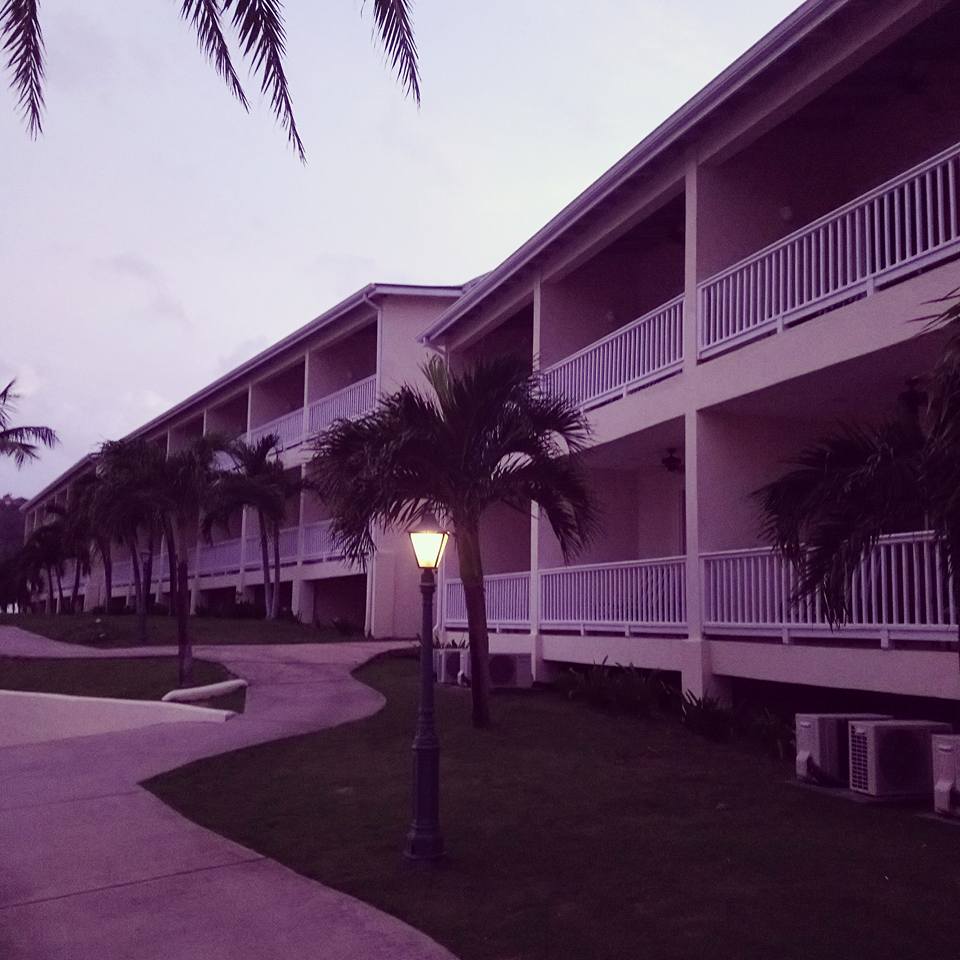 The exterior view of the Royal Suites building at dusk in St James Club Antigua