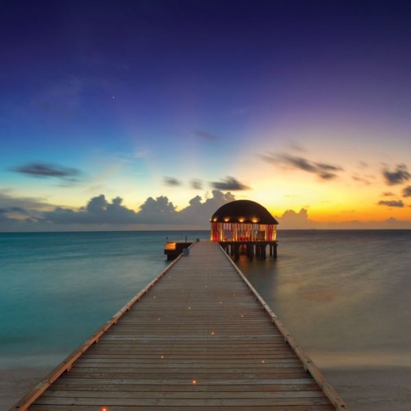 Sunset over the jetty at OZEN by Atmosphere at Maadhoo, Maldives